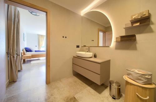 a bathroom with a sink and a mirror at Rooms Salvia in Cres