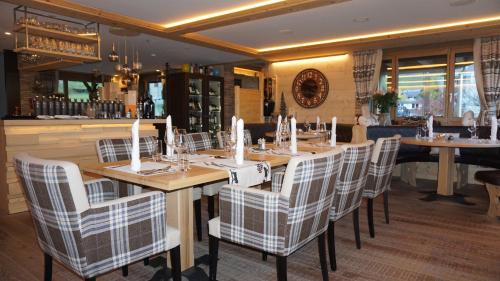 a restaurant with a long wooden table and chairs at Caschu Alp Boutique Design Hotel Stoos - adults only in Stoos