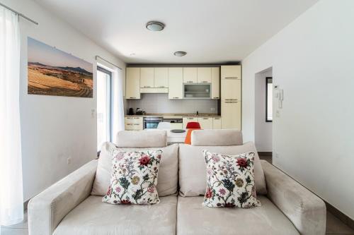 a living room with a couch with two pillows at Casa Mummi by Quokka 360 - with garden 5 min from Ascona in Losone