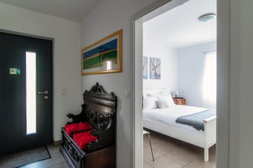 a bedroom with a bed and a door leading into a room at Casa Mummi by Quokka 360 - with garden 5 min from Ascona in Losone