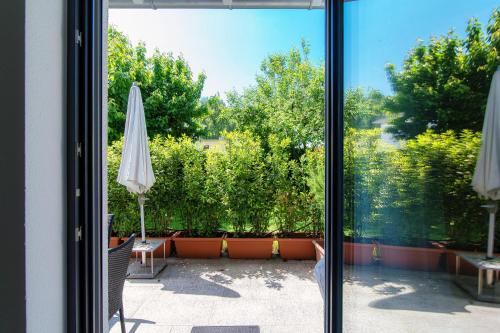 a view of a patio from a window with an umbrella at Casa Mummi by Quokka 360 - with garden 5 min from Ascona in Losone