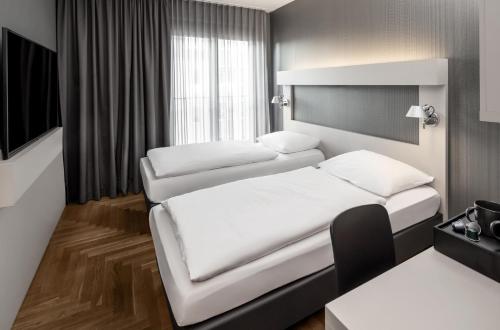 Hotel AMANO Rooms & Apartmentsにあるベッド