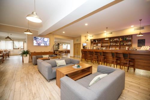 a living room with couches and a bar at Amantis Vital Sport Hotel in Desná