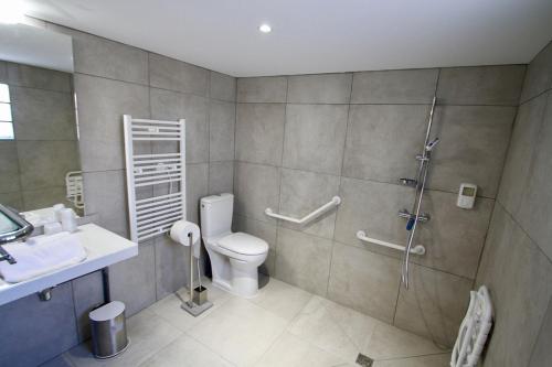 a bathroom with a toilet and a sink and a shower at LA VILLA DU CAP in Cap-Ferret