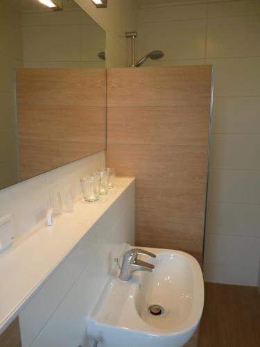 a bathroom with a sink and a mirror at B&B Boutique Hotel De Waal in De Waal