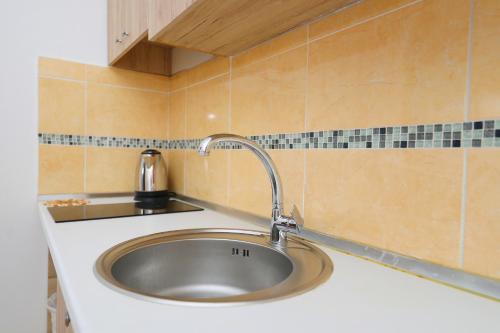 a kitchen sink with a faucet on a counter at Vila Dena in Vlorë