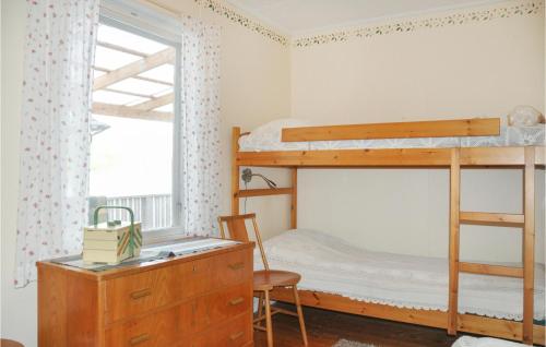 a bedroom with bunk beds and a desk and a chair at Cozy Home In motfors With Lake View in Åmotsfors