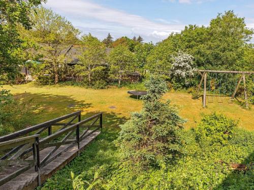 an aerial view of a garden with a wooden bridge at 19 person holiday home in L gst r in Trend