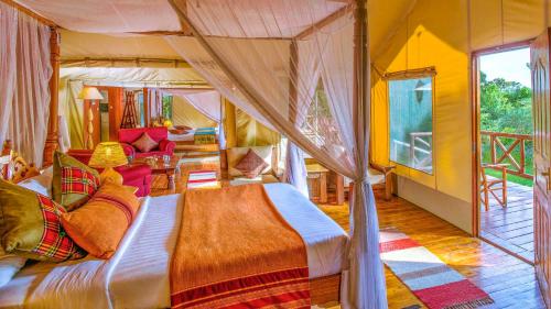 a bedroom with a canopy bed in a room at Mara Leisure Camp in Talek