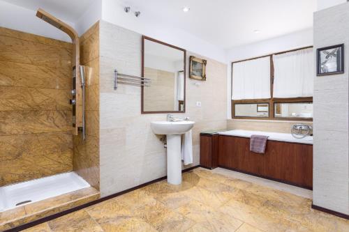 a bathroom with a sink and a shower at Home2Book Ocean Surf House Fuerteventura in La Oliva