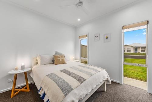 a white bedroom with a bed and a window at Bright & Easy - Address is 7 Cobb & C Way Pet Friendly Inside in Robe