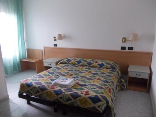 a small bedroom with a bed and two night stands at Scacco Rosso in SantʼEgidio alla Vibrata