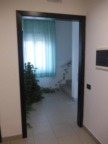 a doorway to a room with a window and a plant at Scacco Rosso in SantʼEgidio alla Vibrata