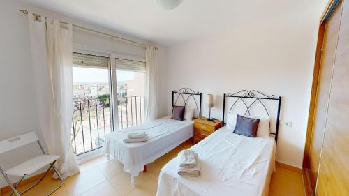 a bedroom with two beds and a balcony at Casa Espliego A-Murcia Holiday Rentals Property in Torre-Pacheco