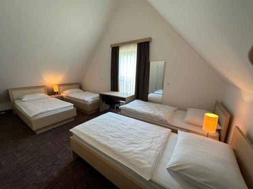 a hotel room with three beds and a mirror at Apartment BRIN in Topolšica