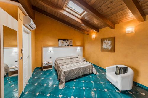 a bedroom with a bed and a chair at Dolce Vita Relais in Sala Consilina