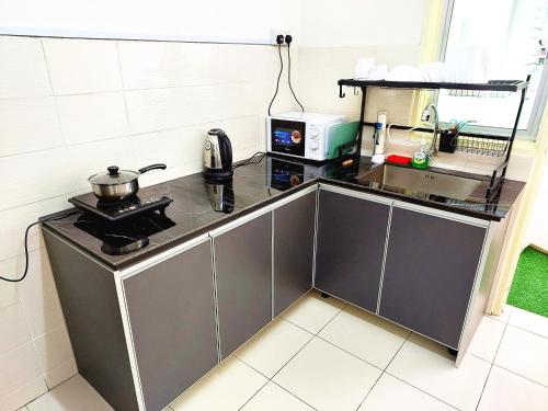 a kitchen with a counter top with a stove at TuR10-Oppesite Pisa Stadium-1min-FoodCourt-MiniMarket in Bayan Lepas