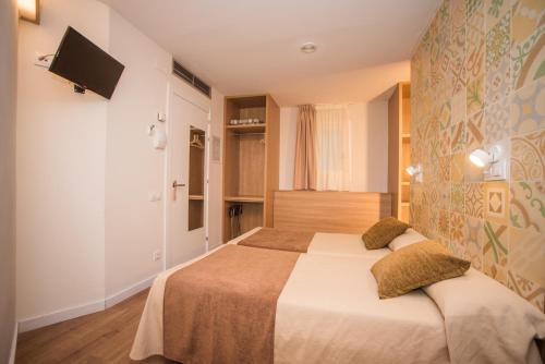 Postel nebo postele na pokoji v ubytování Hostal Marenostrum