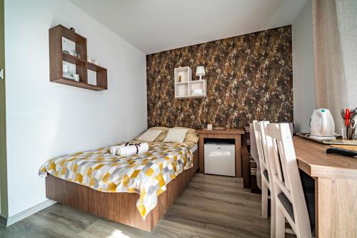 a bedroom with a bed and a desk in it at Pokoje Iga in Władysławowo