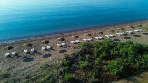 an overhead view of a beach with chairs and the ocean at Grand Bleu Anastazia in Porto Heli