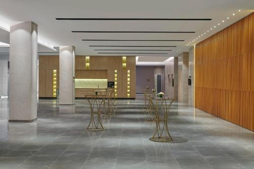 a lobby with chairs and tables in a building at Courtyard by Marriott Melaka in Melaka