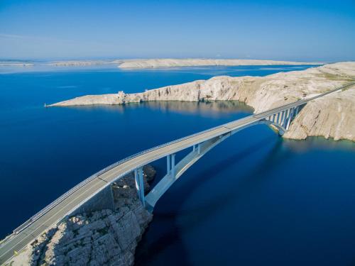 an aerial view of a bridge over a body of water at Family Hotel Pagus - All Inclusive in Pag