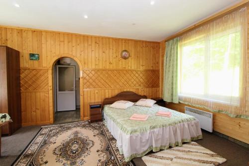 a bedroom with a bed and a window at Cottage "Gribochok" in Yaremche