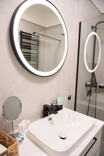 a bathroom with a white sink and a mirror at Nadmorski Loft Rezydencja Niechorze 116 plaża ogród in Niechorze
