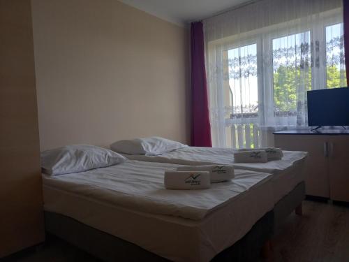a bedroom with a bed with two boxes on it at Halny Natura Tour in Karpacz