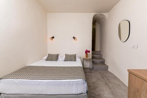 a bedroom with a bed and a mirror on the wall at Amvikas suites-Sitia, by Comfortbnb in Sitia