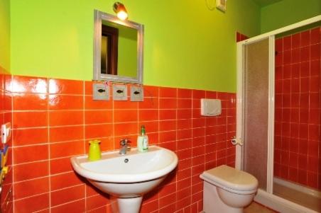 a bathroom with a sink and a toilet at Butterfly House Bed & Breakfast in Alghero