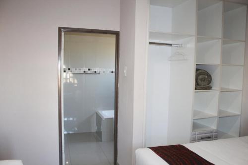a bathroom with a shower and a bed and a sink at Mmathaba Guest House in Mmadinare