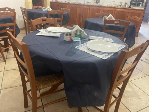 a table with a blue table cloth on it at Bed and breakfast KALE ' in Porto Cesareo