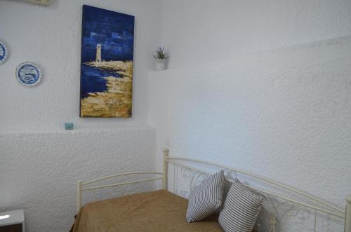 ein Schlafzimmer mit einem Bett und einem Wandgemälde in der Unterkunft Rania Bella Vista Studios in Poros