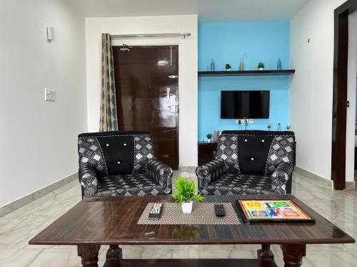 a living room with two chairs and a table at Jasmine 3BHK by Wabi Sabi Stays with Private Balcony in Rishīkesh