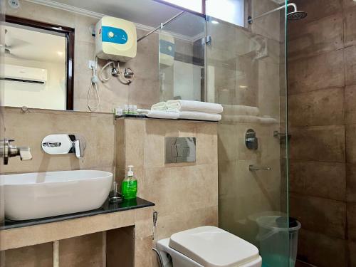 a bathroom with a sink and a toilet and a shower at Jasmine 3BHK by Wabi Sabi Stays with Private Balcony in Rishīkesh