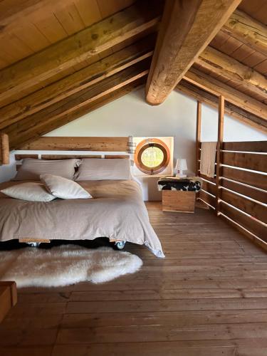 a bedroom with a bed and a wooden ceiling at Chalet Palù in Brosso