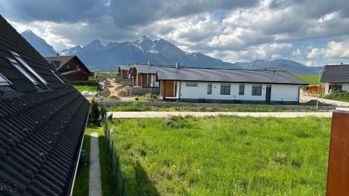 a house in a field with mountains in the background at 2 room Apartment, mountains view, Stará Lesná in Stará Lesná