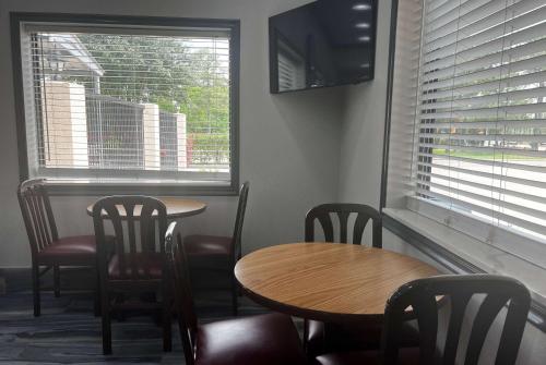 a restaurant with two tables and chairs and a window at Super 8 by Wyndham Pasadena in Pasadena