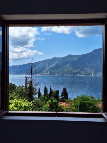 a view of a lake from a window at B & M Apartments in Kotor
