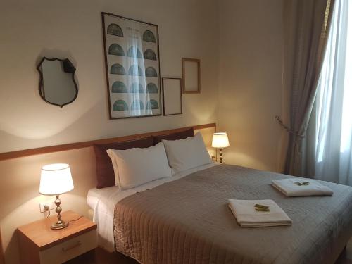 a bedroom with a bed with two towels on it at Villa Alle Rampe in Florence