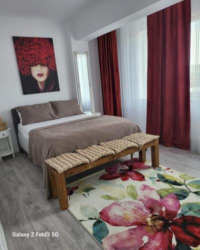 a bedroom with a bed and a flower rug at David’s place in Floreşti