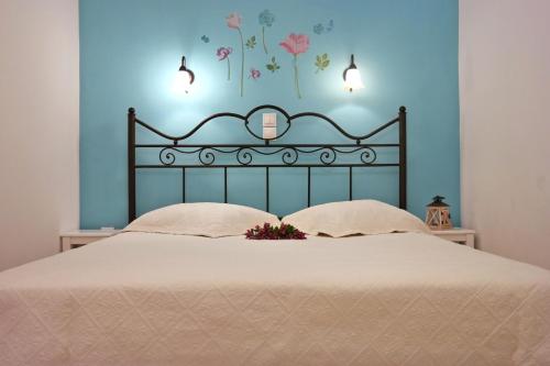 1 dormitorio con 1 cama con pared azul en Magic Land, en Plaka