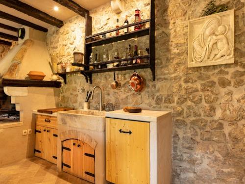 a kitchen with a sink and a counter top at Authentic Stone House Lola in Makarska