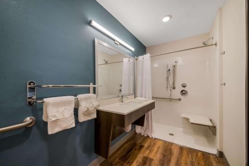 a bathroom with a sink and a mirror at WoodSpring Suites Inverness in Inverness
