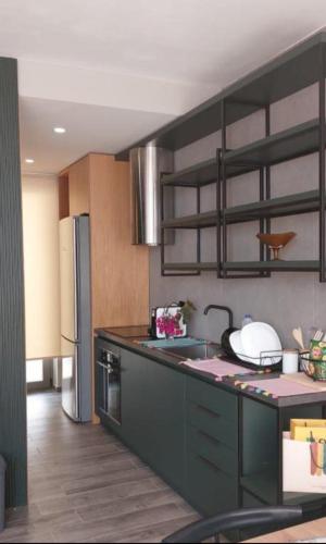 a kitchen with a sink and a refrigerator at Private Villa at Olea Luxury Resort in Dhërmi