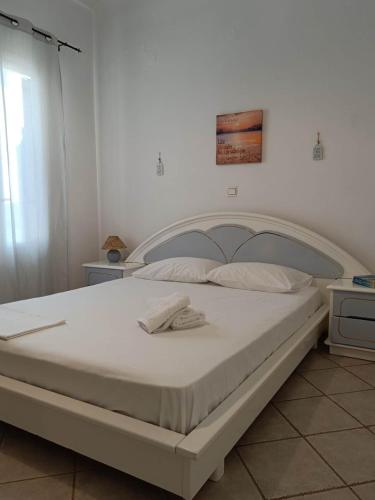 a bedroom with a large white bed in a room at Sea view Cycladic house in Tinos