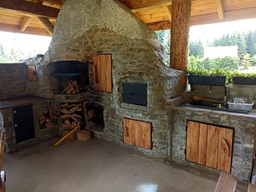 a stone oven with a kitchen and a sink at Domek na Polance in Istebna