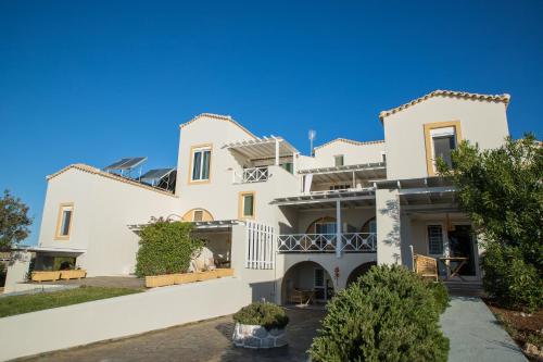 a large white house with a blue sky at Grand Bleu Anastazia in Porto Heli
