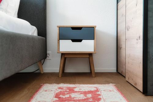 a tv sitting on a table next to a bed at Linda Terrace by Quokka 360 - modern one-bedroom flat with sun terrace in Locarno